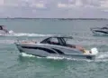 Three Hanover Yachts models running on the water with skyline behind