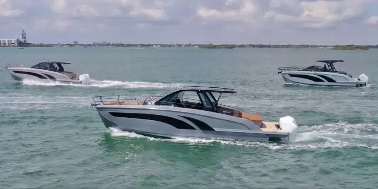 Three Hanover Yachts models running on the water with skyline behind