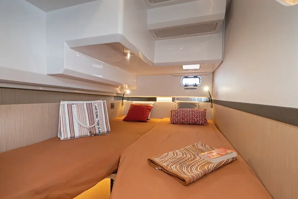 Climate-controlled cabin aboard the Jeanneau TH38 with a queen berth and natural light from hull windows