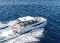 Jeanneau TH38 power catamaran running offshore at speed under a clear sky