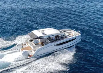 Jeanneau TH38 power catamaran running offshore at speed under a clear sky