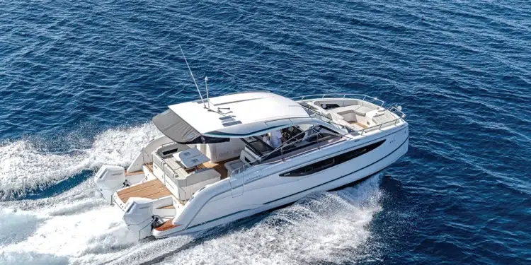 Jeanneau TH38 power catamaran running offshore at speed under a clear sky