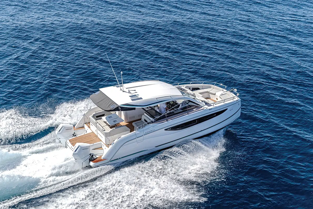 Jeanneau TH38 power catamaran running offshore at speed under a clear sky