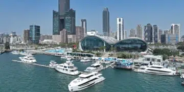 Horizon yachts berthed at Horizon City Marina below the Kaohsiung skyline in Taiwan
