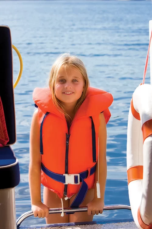 A young girl wears a lifejacket