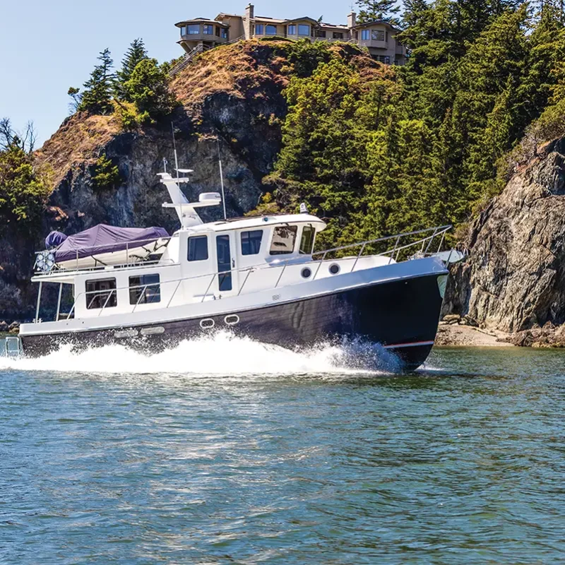 American Tug 435 white boat with dark hull tug boat running in the water