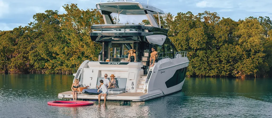 Cruisers FLY 57 idle in the water with a family on board