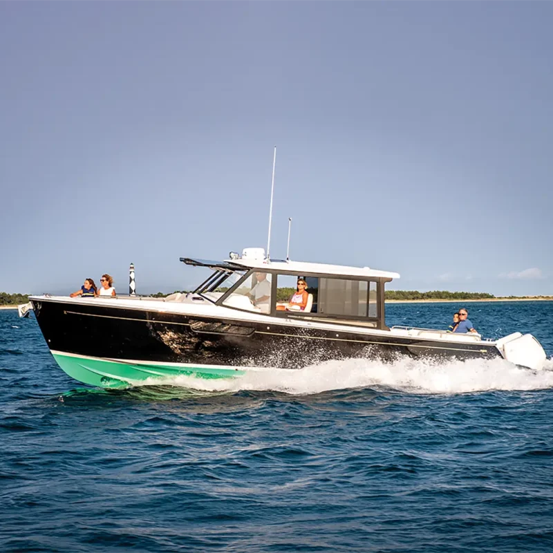 MJM 3 with a green bottom hull running in the water