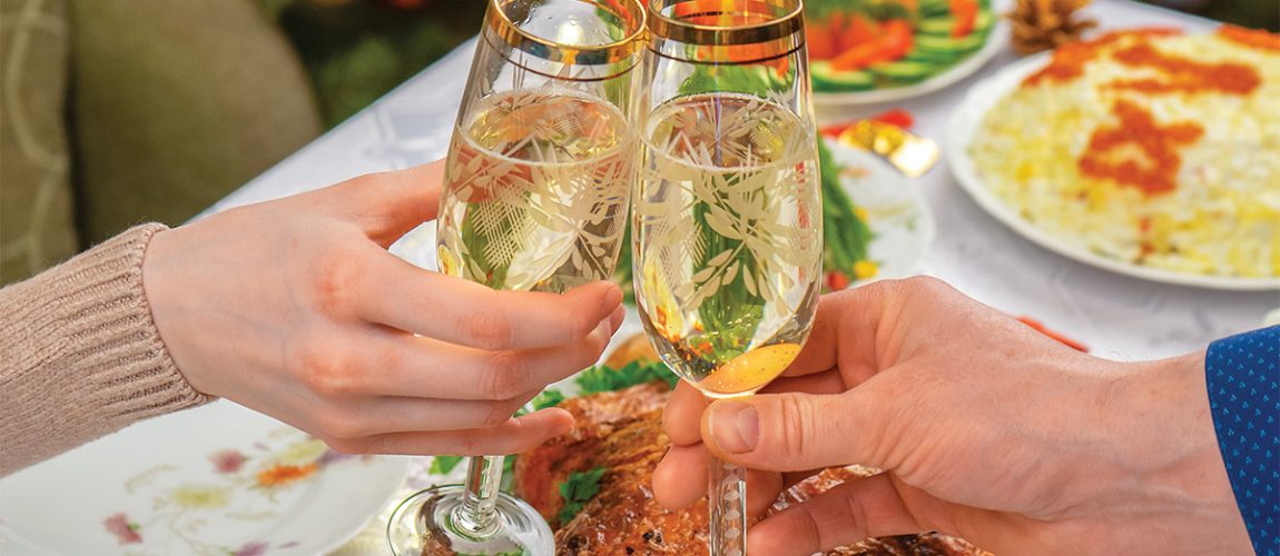 a couple sharing champagne during a holiday boat party